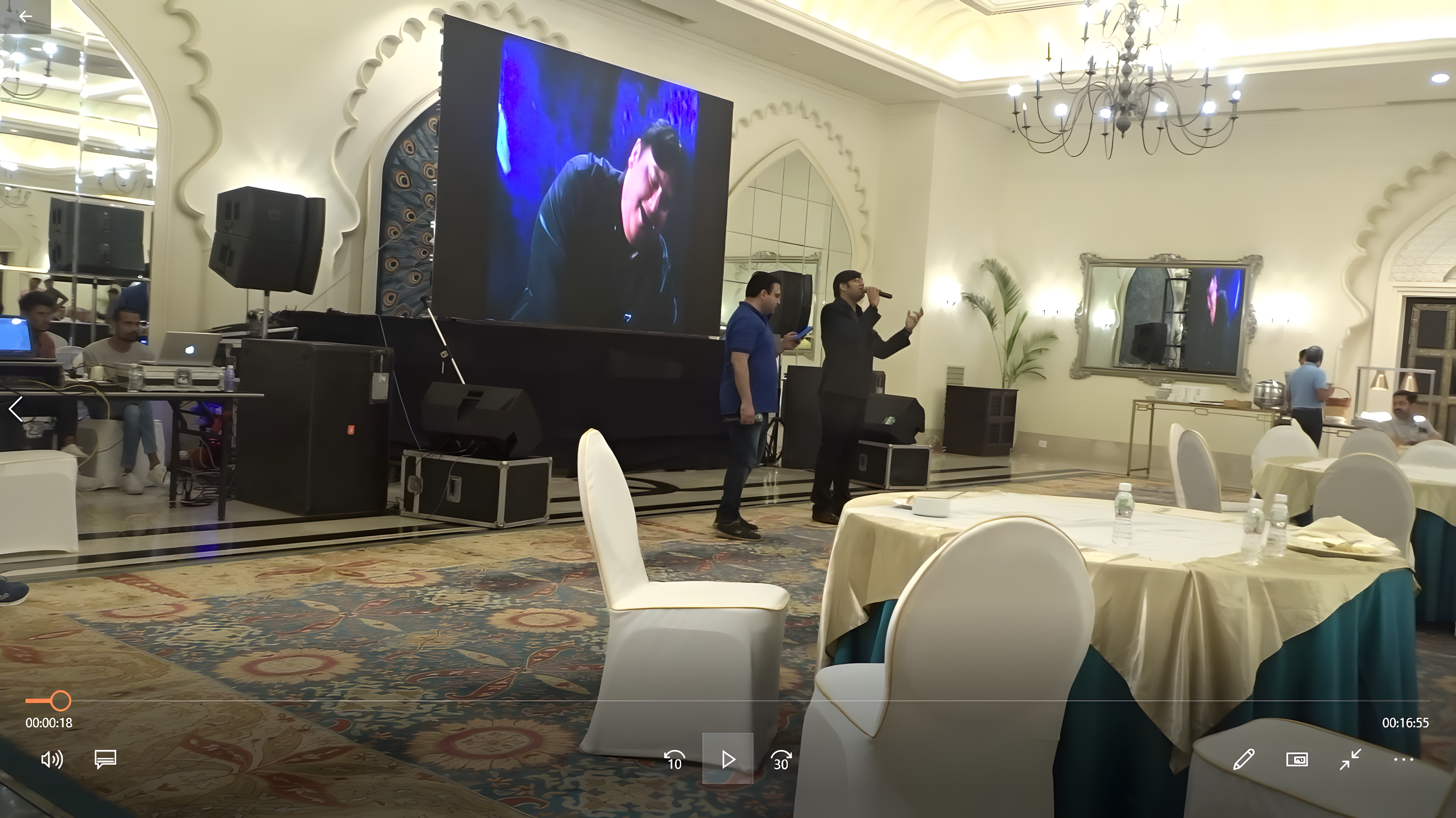 Dr. Arpit Deliwala on stage with microphone